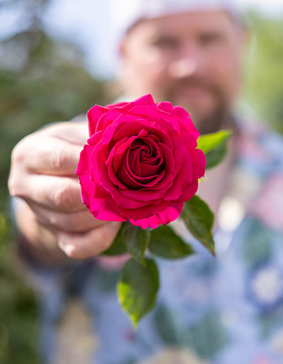 Mark Taylor holding red rose